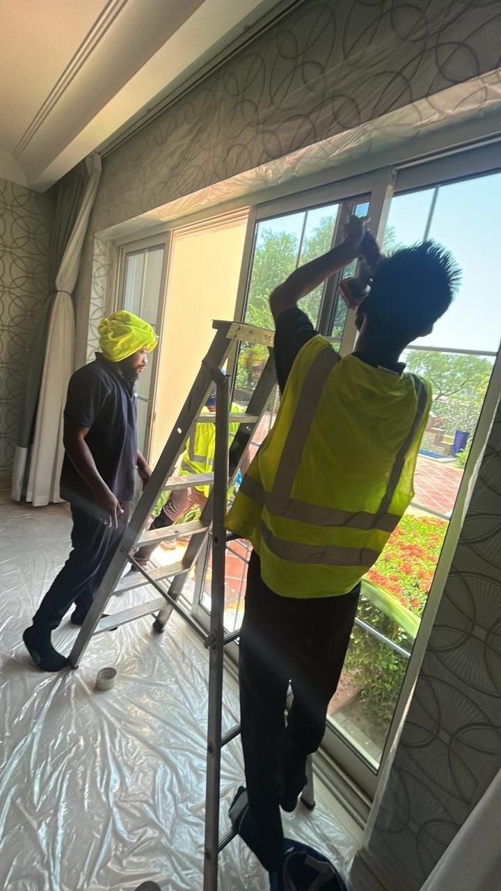Vocus team installing a full-height sliding door unit, Dubai