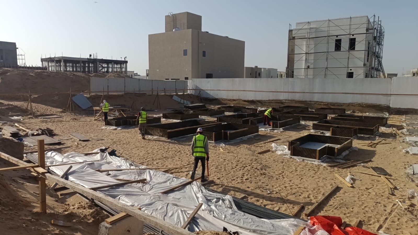 Grid of pad-footing formwork ready for reinforcement on a Vocus villa construction site, Dubai