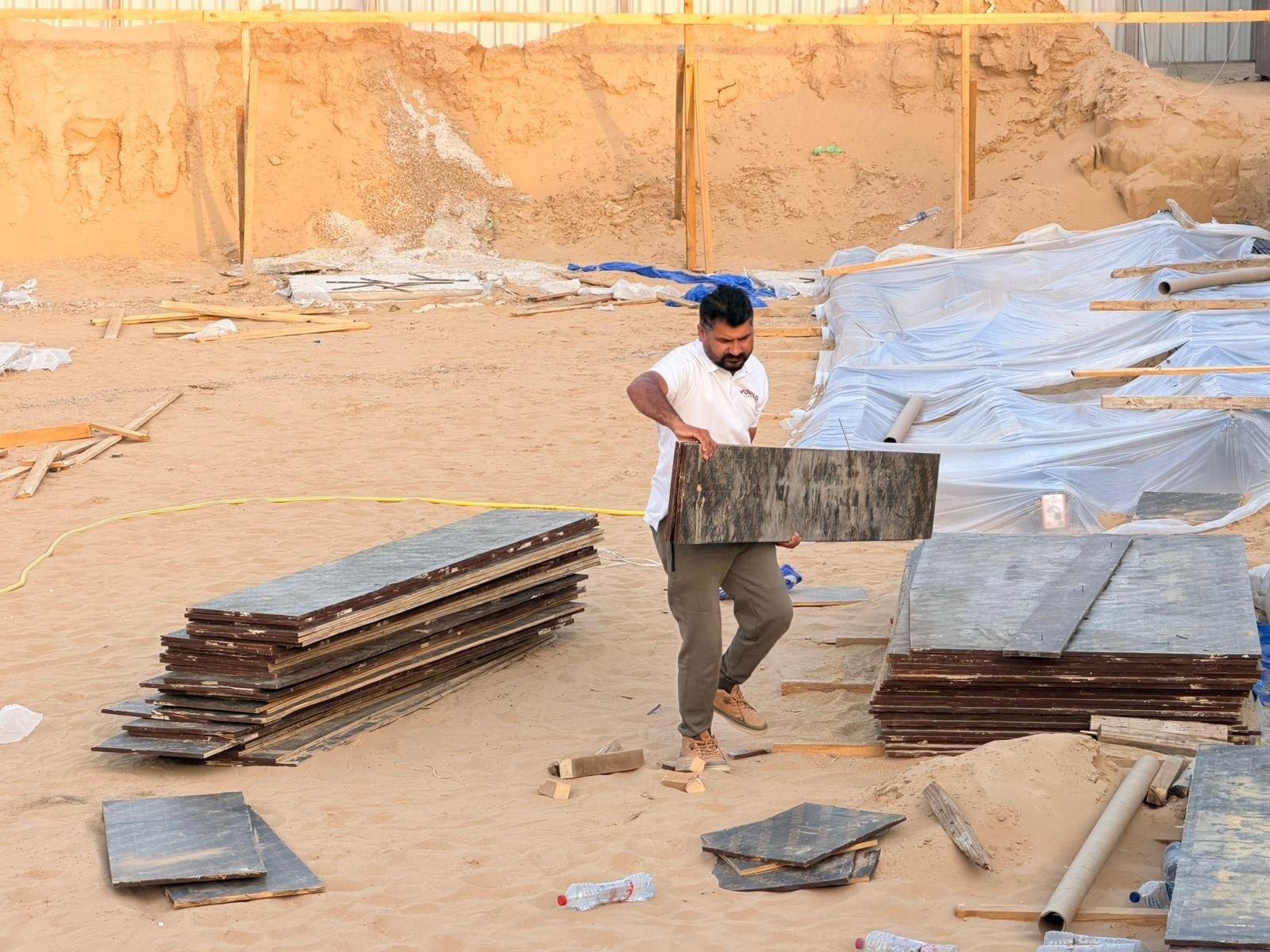 Vocus crew handling and checking formwork panels ahead of a concrete pour, Al Aweer First, Dubai